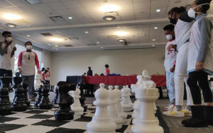 Children playing life size chess board at a Chess and Community Event